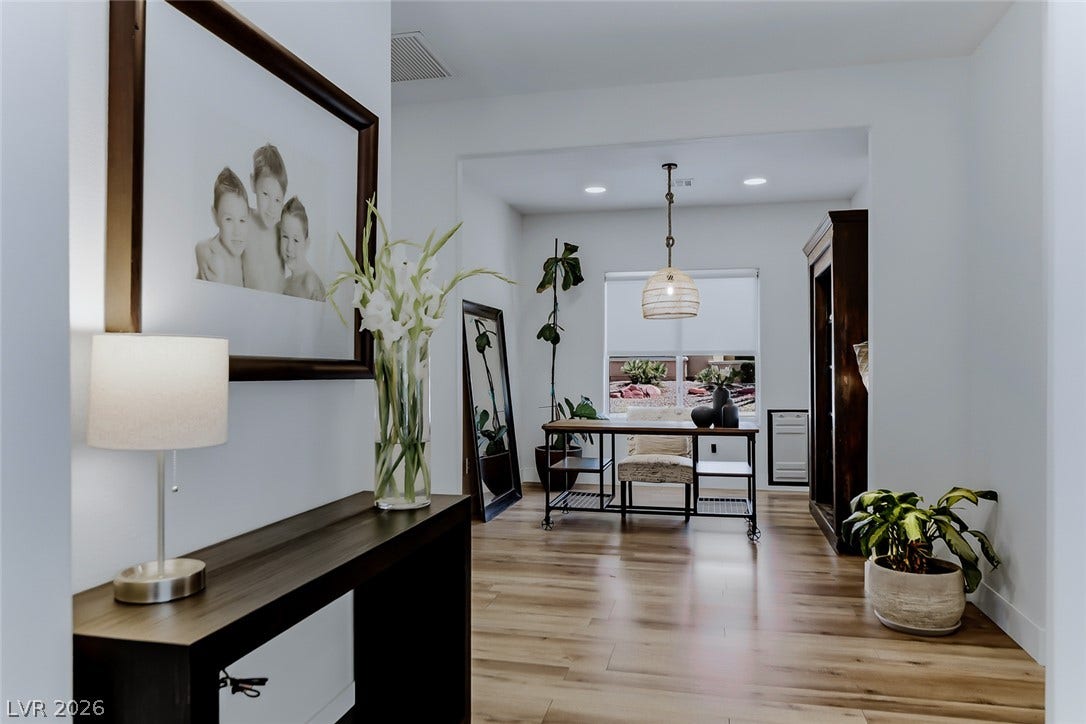 2601 Arimo Drive, Henderson, NV 89052 Gleaming hardwood floors and recessed lighting enhance this versatile home office off the foyer.