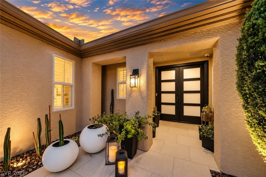 2601 Arimo Drive, Henderson, NV 89052 Textured stucco walls and tiled pathways frame a welcoming entrance with striking double doors.