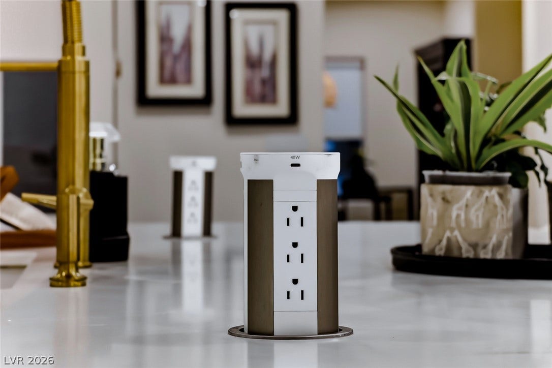 2601 Arimo Drive, Henderson, NV 89052 Modern pop-up electrical outlets integrate seamlessly into the smooth stone countertops.