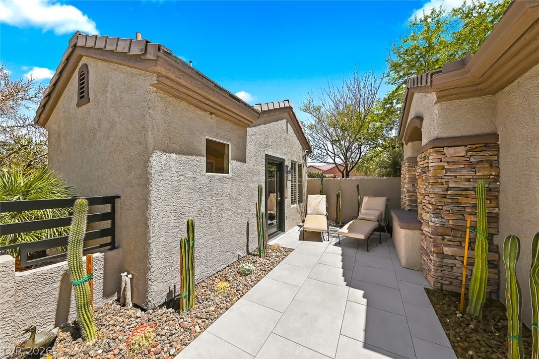 2601 Arimo Drive, Henderson, NV 89052 Tiled paths wind past desert plantings and textured stone pillars on this private patio.