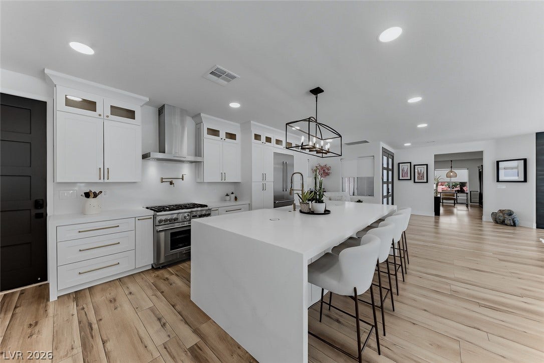 2601 Arimo Drive, Henderson, NV 89052 Smooth wood flooring and a massive waterfall island ground this bright, open kitchen.