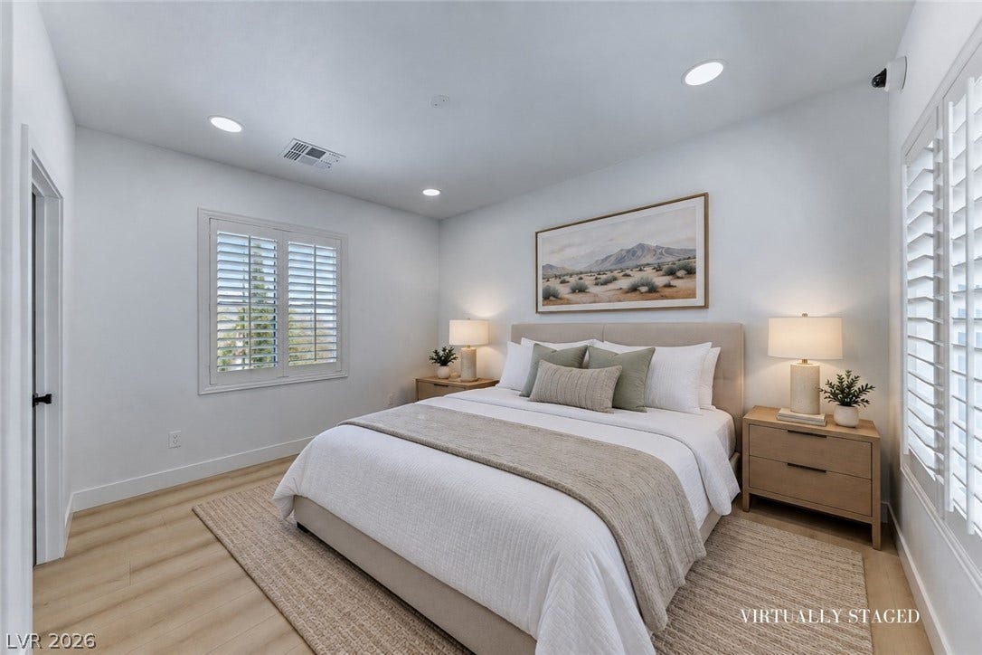 2601 Arimo Drive, Henderson, NV 89052 Recessed lighting illuminates this inviting space featuring light wood floors and plantation shutters.