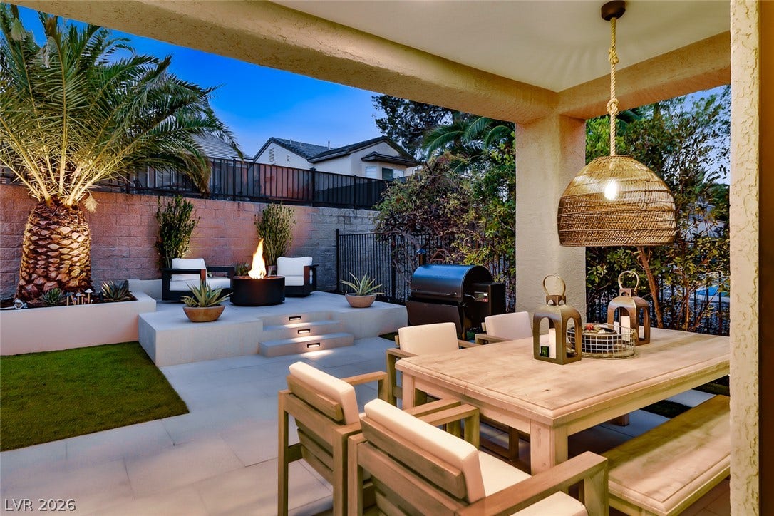 2601 Arimo Drive, Henderson, NV 89052 An inviting covered terrace transitions seamlessly to a multi-level stone patio with built-in fire pit.