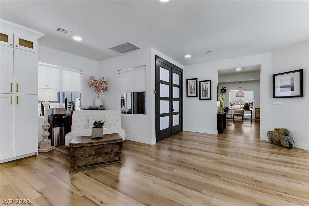 2601 Arimo Drive, Henderson, NV 89052 Gleaming wood-look floors flow through this light-filled entryway highlighting clean architectural lines.
