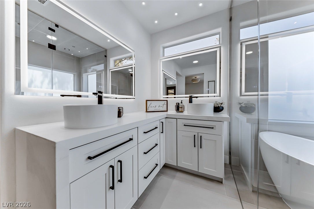 2601 Arimo Drive, Henderson, NV 89052 Clean lines and a freestanding soaking tub define this modern primary bathroom.