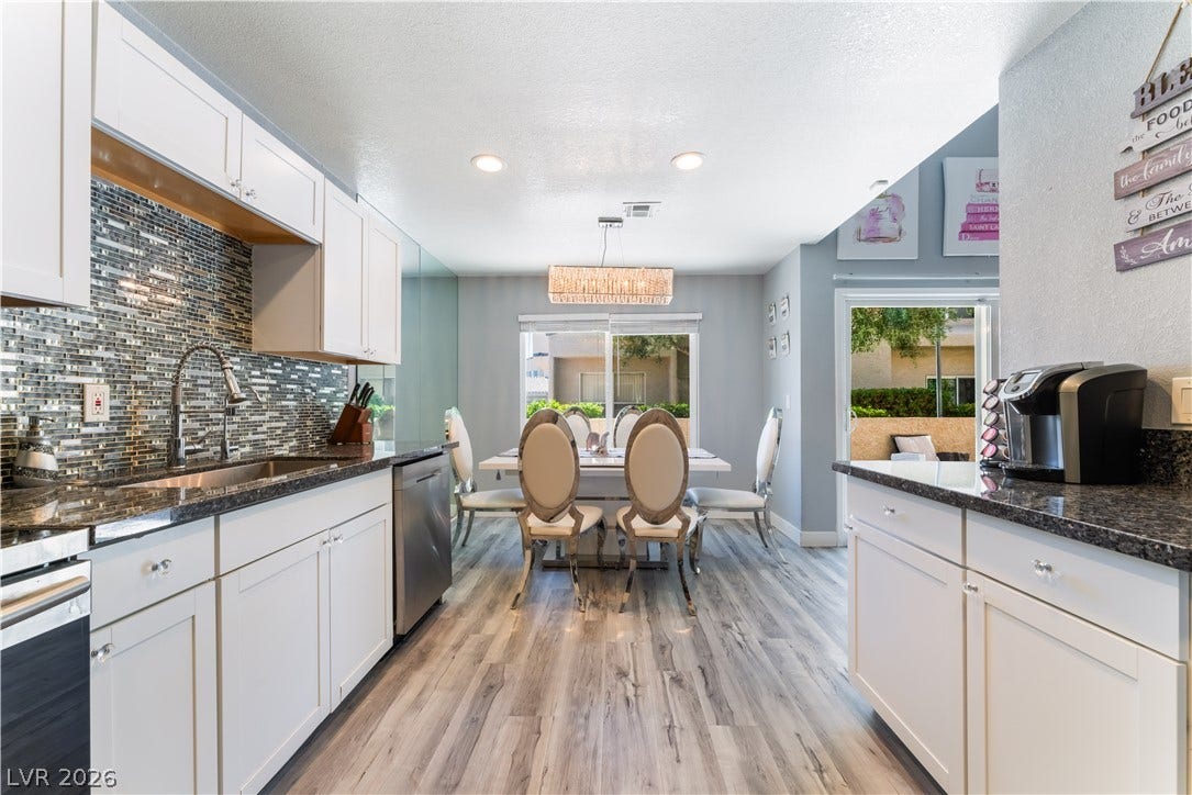 6250 W Flamingo Road, #37, Las Vegas, NV 89103 A well-lit kitchen with sleek countertops and an adjacent dining area offering outdoor access.