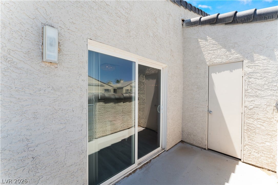 6250 W Flamingo Road, #37, Las Vegas, NV 89103 A well-maintained stucco exterior features a sliding glass door and a convenient storage closet.