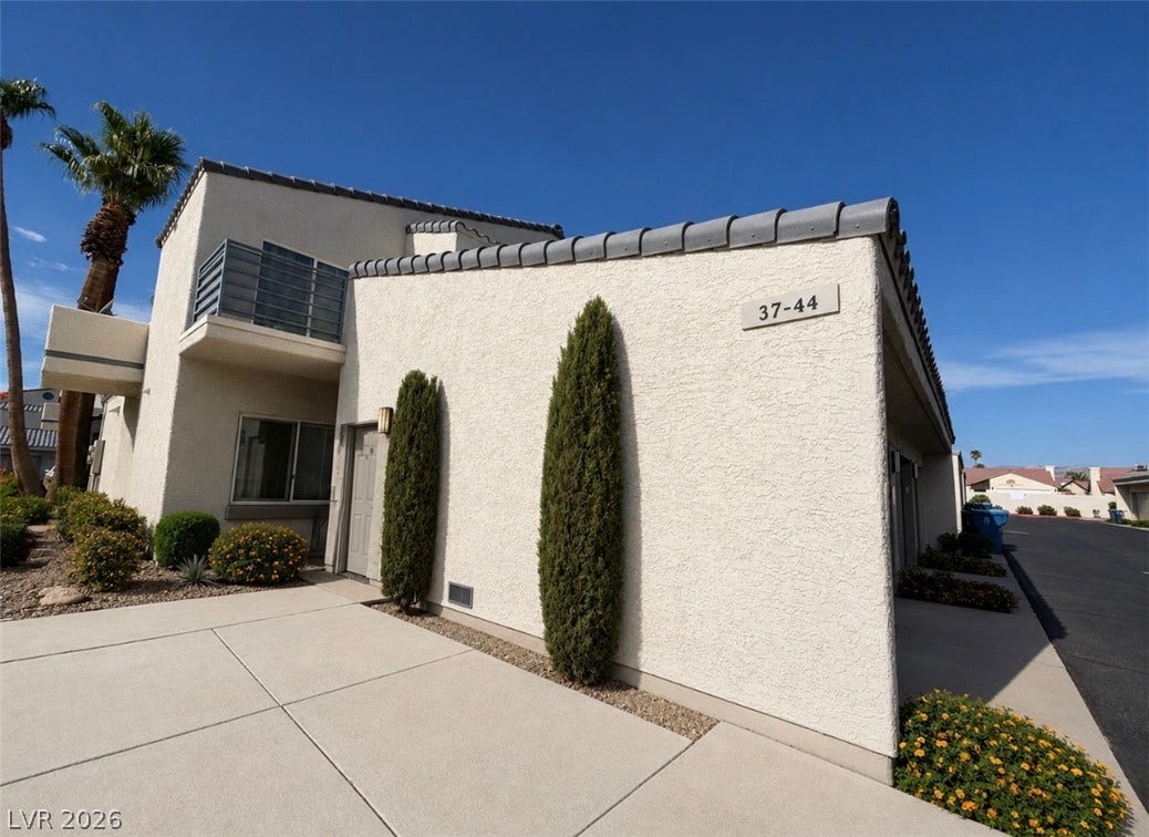 6250 W Flamingo Road, #37, Las Vegas, NV 89103 Crisp stucco architecture paired with concrete walkways under a clear desert sky.