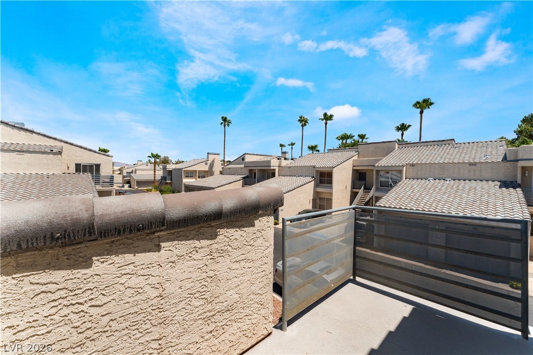 6250 W Flamingo Road, #37, Las Vegas, NV 89103 Overlooking the vibrant community, this upper-level outdoor space offers an inspiring vista of the surrounding residences and natural landscaping.