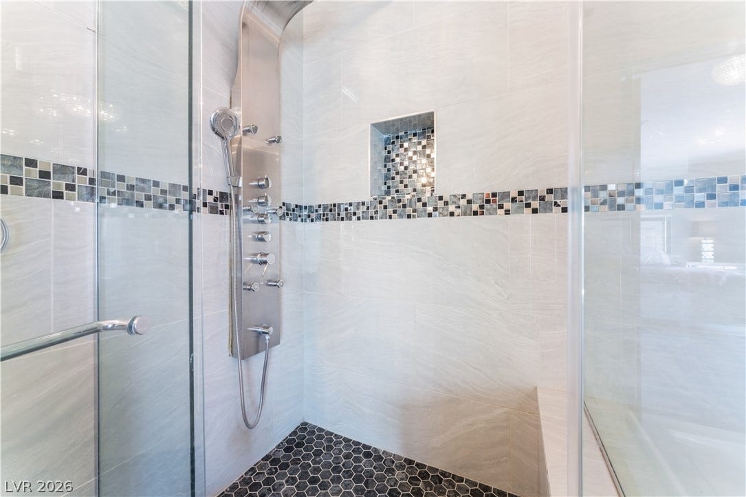 6250 W Flamingo Road, #37, Las Vegas, NV 89103 Indulge in a luxurious shower experience featuring a multi-function panel and stylish tilework.