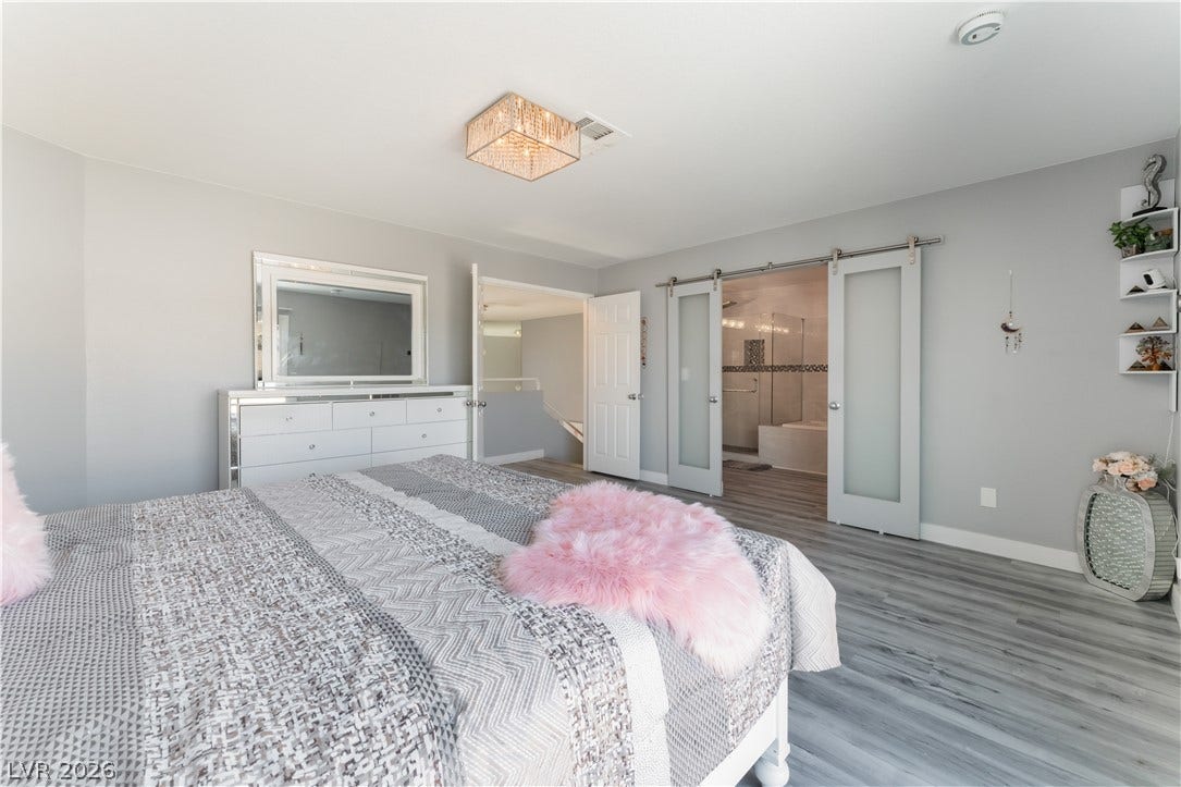 6250 W Flamingo Road, #37, Las Vegas, NV 89103 Luminous bedroom with elegant sliding doors revealing an adjacent primary bath, creating a serene personal retreat.