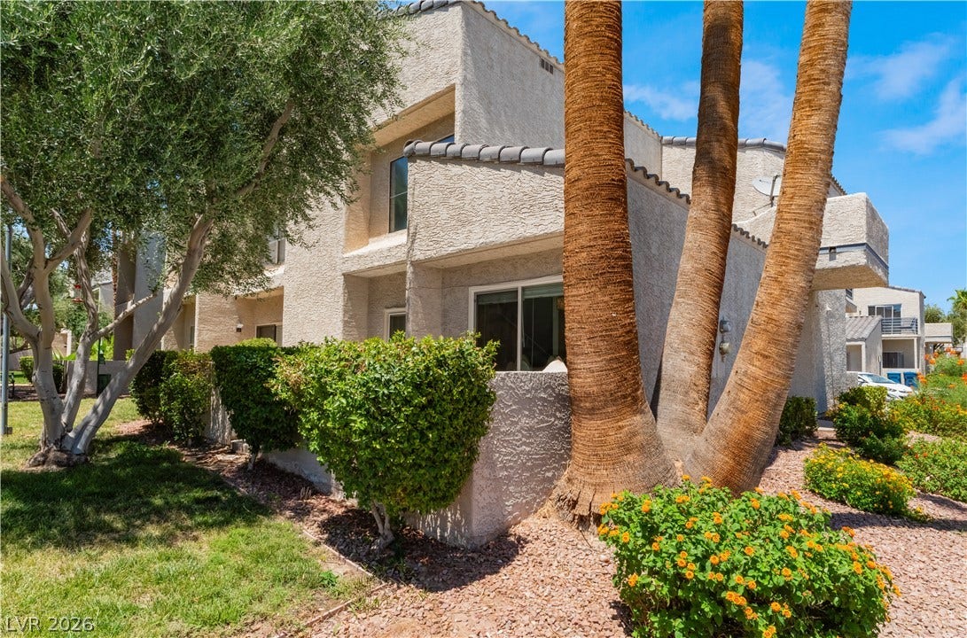 6250 W Flamingo Road, #37, Las Vegas, NV 89103 The textured stucco exterior of this multi-story building is framed by lush, well-maintained landscaping and towering palm trees.