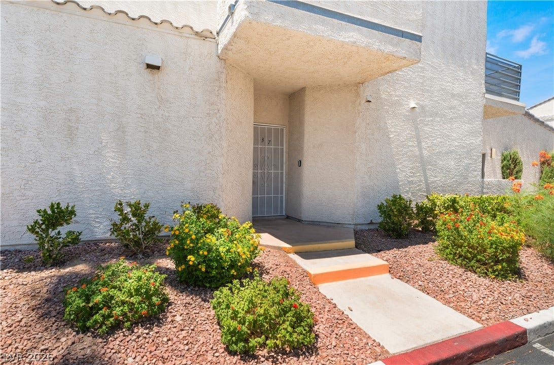 6250 W Flamingo Road, #37, Las Vegas, NV 89103 A welcoming entry, with a security door and vibrant landscaping, provides curb appeal.