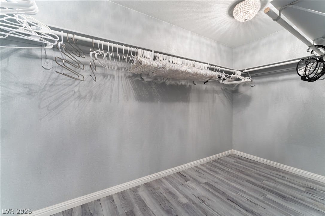 6250 W Flamingo Road, #37, Las Vegas, NV 89103 Ample hanging space and chic flooring define this practical walk-in closet.