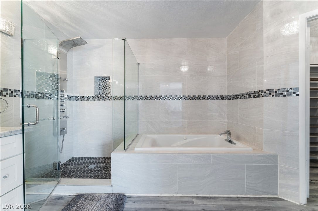 6250 W Flamingo Road, #37, Las Vegas, NV 89103 Indulge in a primary bathroom retreat featuring a luxurious soaking tub and a spacious walk-in shower.