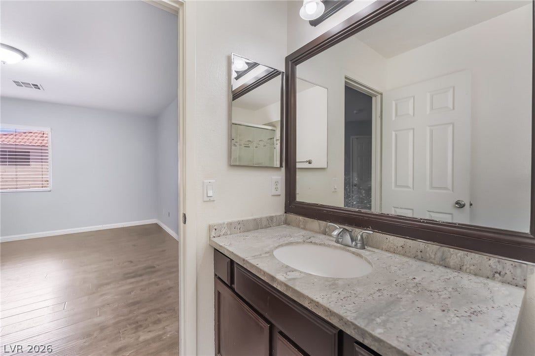 Bathroom featuring vanity and light wood finished floors