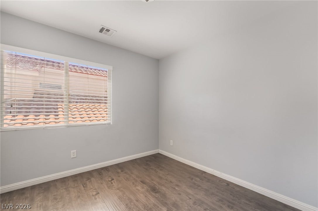 Empty room with baseboards and wood finished floors