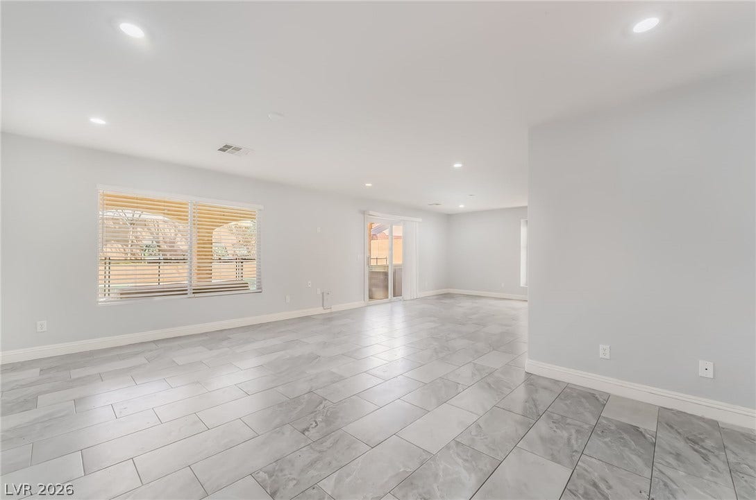 Unfurnished room featuring recessed lighting and baseboards