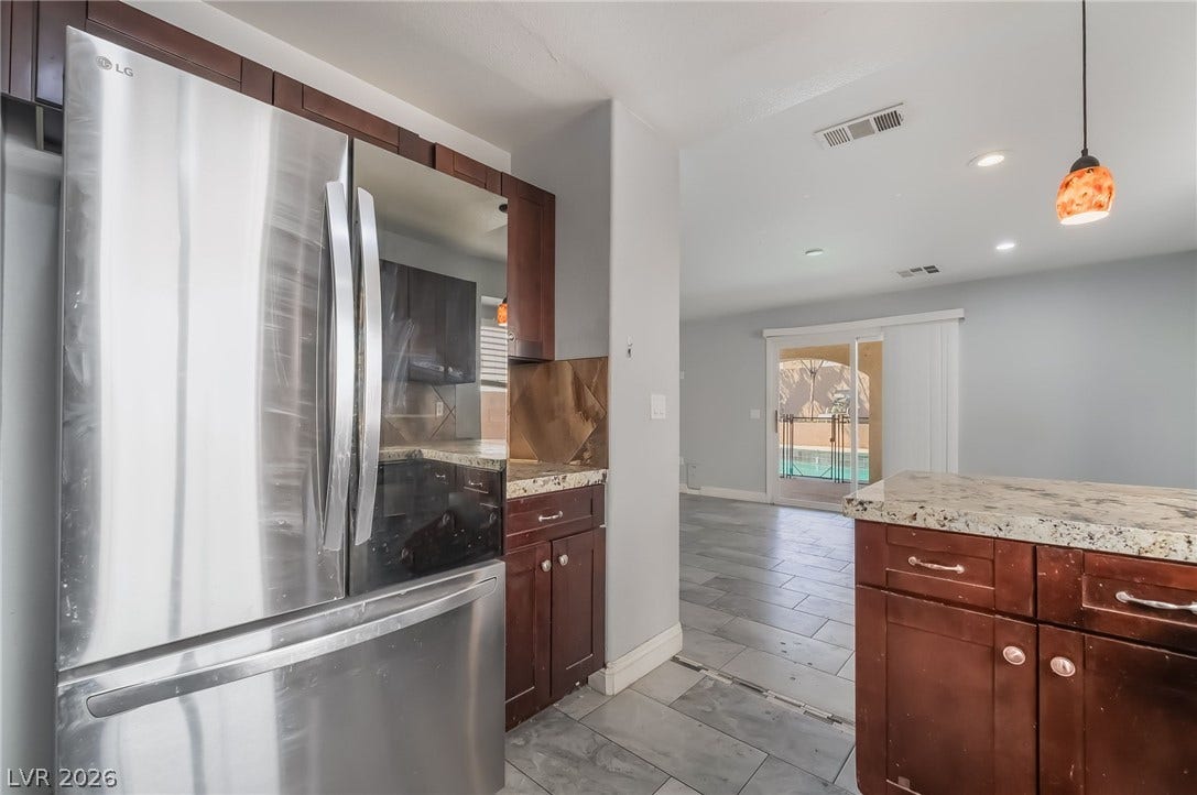 Kitchen with smart refrigerator, decorative light fixtures, recessed lighting, and decorative backsplash