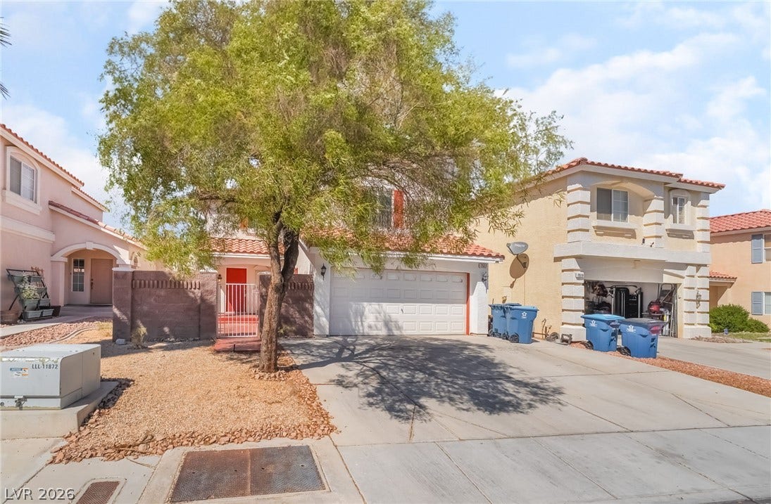 Mediterranean / spanish home with a tile roof, stucco siding, driveway, and a garage