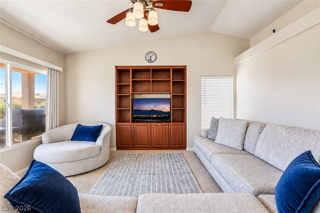 6771 Bravura Court, Las Vegas, NV 89139 Vaulted ceilings and a handsome built-in media center elevate this comfortable living space.