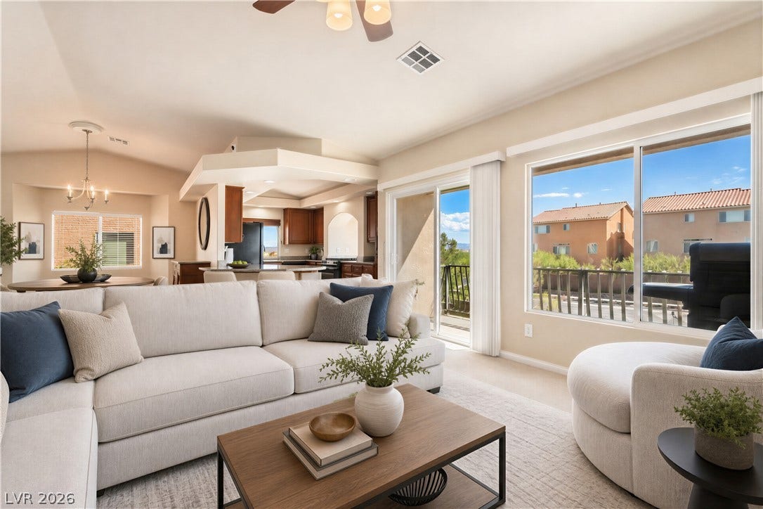 6771 Bravura Court, Las Vegas, NV 89139 Large windows and sliding glass doors fill the main living space with abundant natural light.