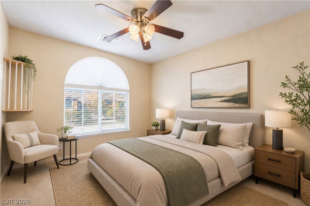 6771 Bravura Court, Las Vegas, NV 89139 An arched window floods the carpeted bedroom with natural light.