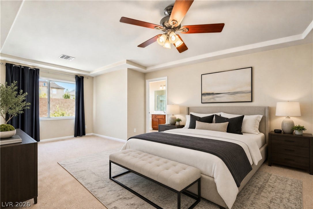 6771 Bravura Court, Las Vegas, NV 89139 An airy tray ceiling and soft wall-to-wall carpeting define this comfortable primary bedroom suite.