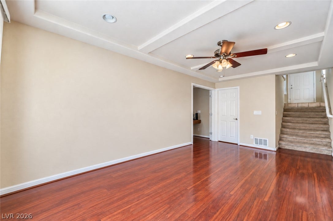 6771 Bravura Court, Las Vegas, NV 89139 Gleaming hardwood floors and a tray ceiling define this versatile living space.