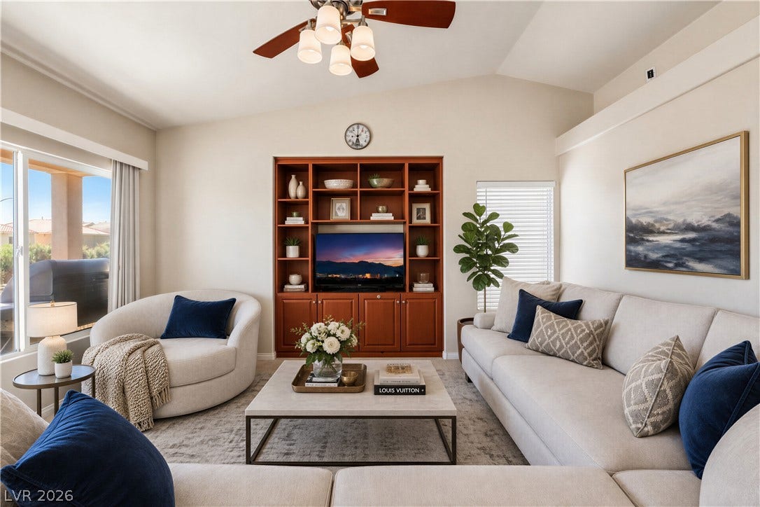 6771 Bravura Court, Las Vegas, NV 89139 Vaulted ceilings and a built-in media center elevate this comfortable living space.