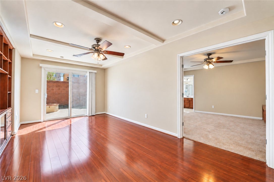 6771 Bravura Court, Las Vegas, NV 89139 Polished hardwood floors and tray ceilings define this versatile open living space.
