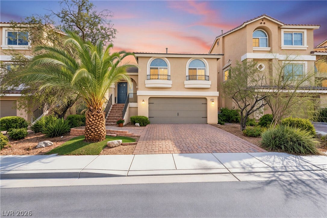 6771 Bravura Court, Las Vegas, NV 89139 Arched windows and a paver driveway define the Mediterranean-inspired facade of this multi-level residence.