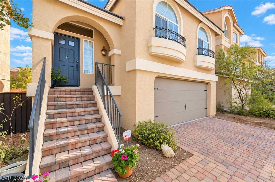 6771 Bravura Court, Las Vegas, NV 89139 Inviting arched entryways and a paved driveway complement this classic multi-level stucco home.