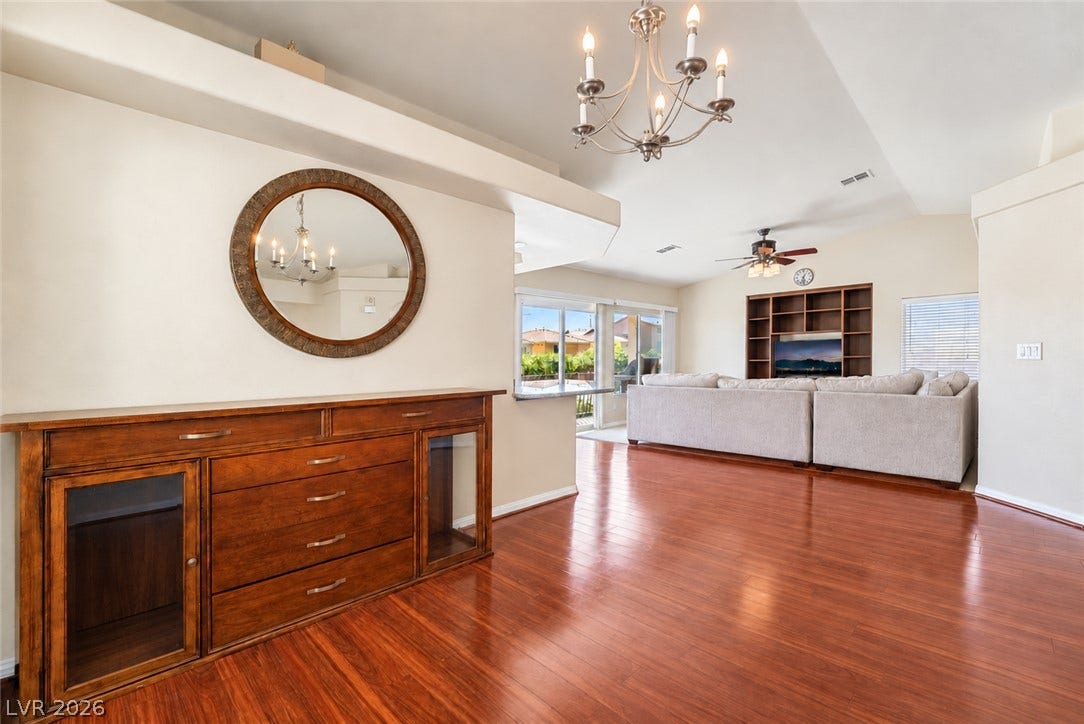 6771 Bravura Court, Las Vegas, NV 89139 Polished wood floors and high ceilings flow throughout this open living and dining space.