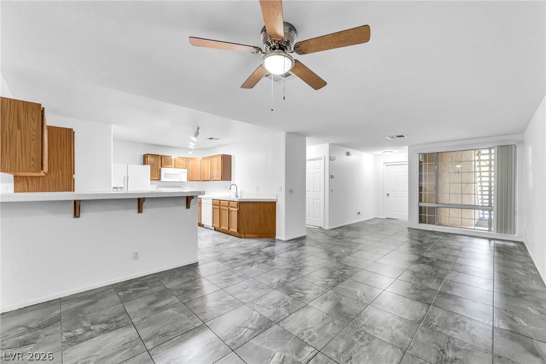 3613 Shawn Reynolds Court, #104, Las Vegas, NV 89129 Polished tile flooring flows seamlessly through this open-concept layout connecting the main living areas.
