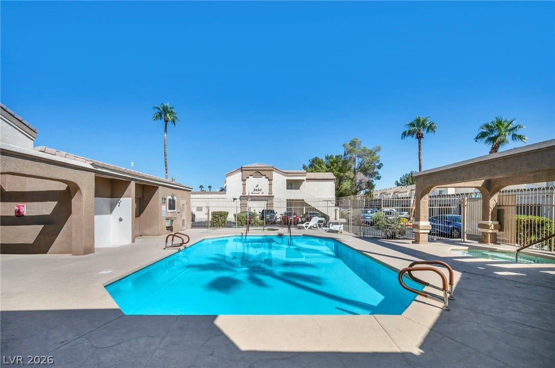 3613 Shawn Reynolds Court, #104, Las Vegas, NV 89129 An inviting swimming pool and adjacent spa sit under a clear blue sky.