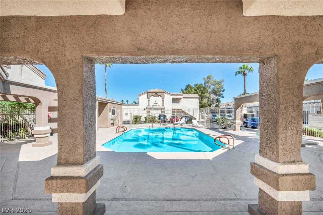 3613 Shawn Reynolds Court, #104, Las Vegas, NV 89129 Framed by arched stucco pillars, a sparkling pool offers a relaxing retreat.