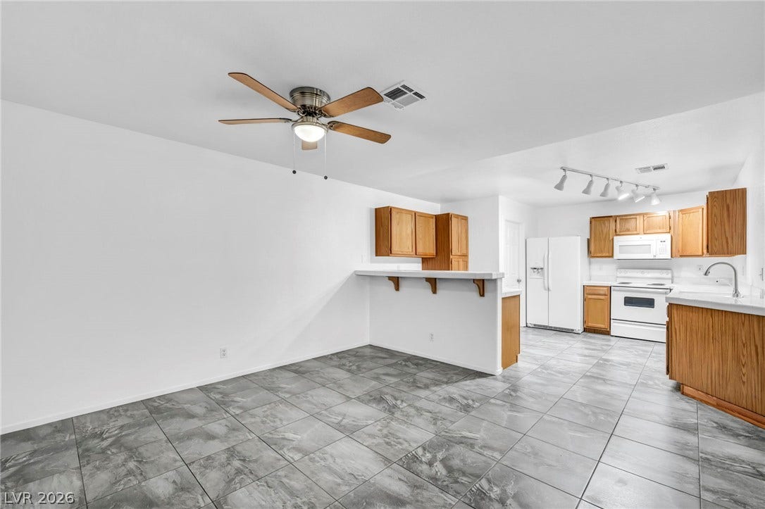 3613 Shawn Reynolds Court, #104, Las Vegas, NV 89129 Tiled flooring flows seamlessly from the versatile dining area directly into the kitchen.