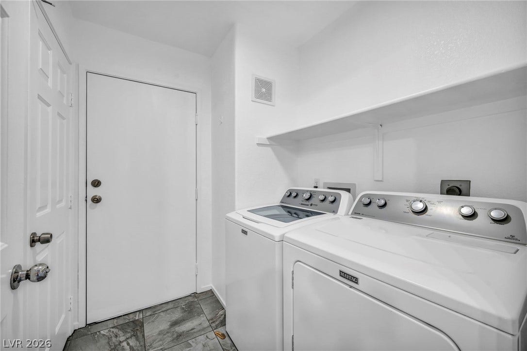 3613 Shawn Reynolds Court, #104, Las Vegas, NV 89129 Functional laundry space features durable tile flooring and overhead storage shelving.