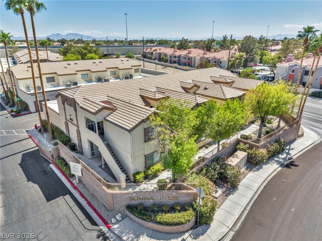 3613 Shawn Reynolds Court, #104, Las Vegas, NV 89129 An elevated perspective showcases the tiled roofline and surrounding desert neighborhood under clear blue skies.