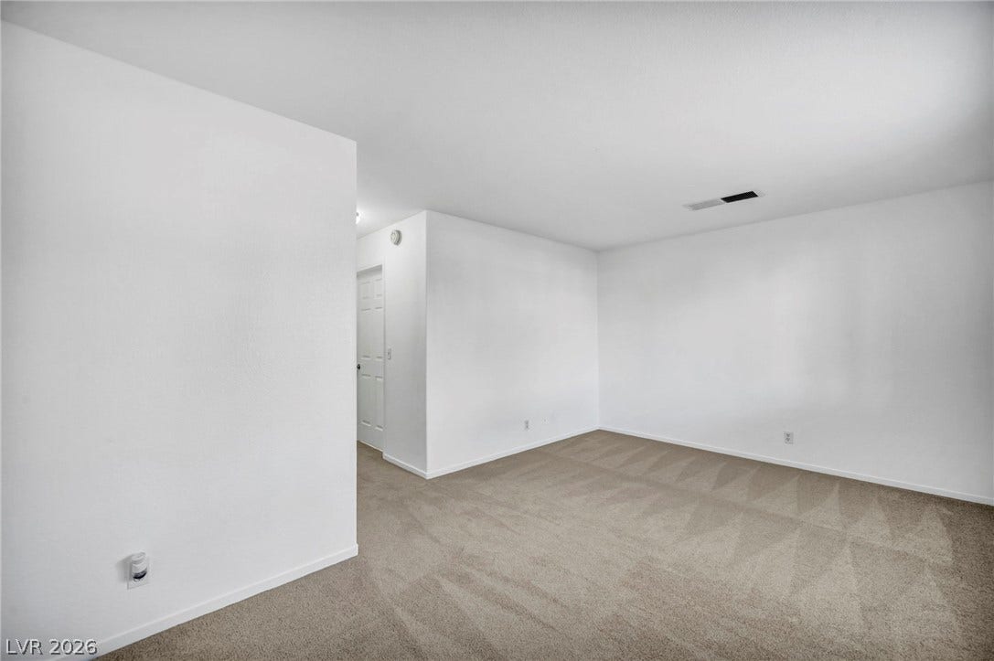 3613 Shawn Reynolds Court, #104, Las Vegas, NV 89129 Crisp white walls and plush neutral carpeting define this versatile, open living area.