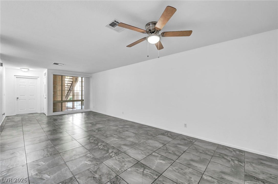 3613 Shawn Reynolds Court, #104, Las Vegas, NV 89129 Gleaming tile floors stretch across a spacious, open living area with large windows.