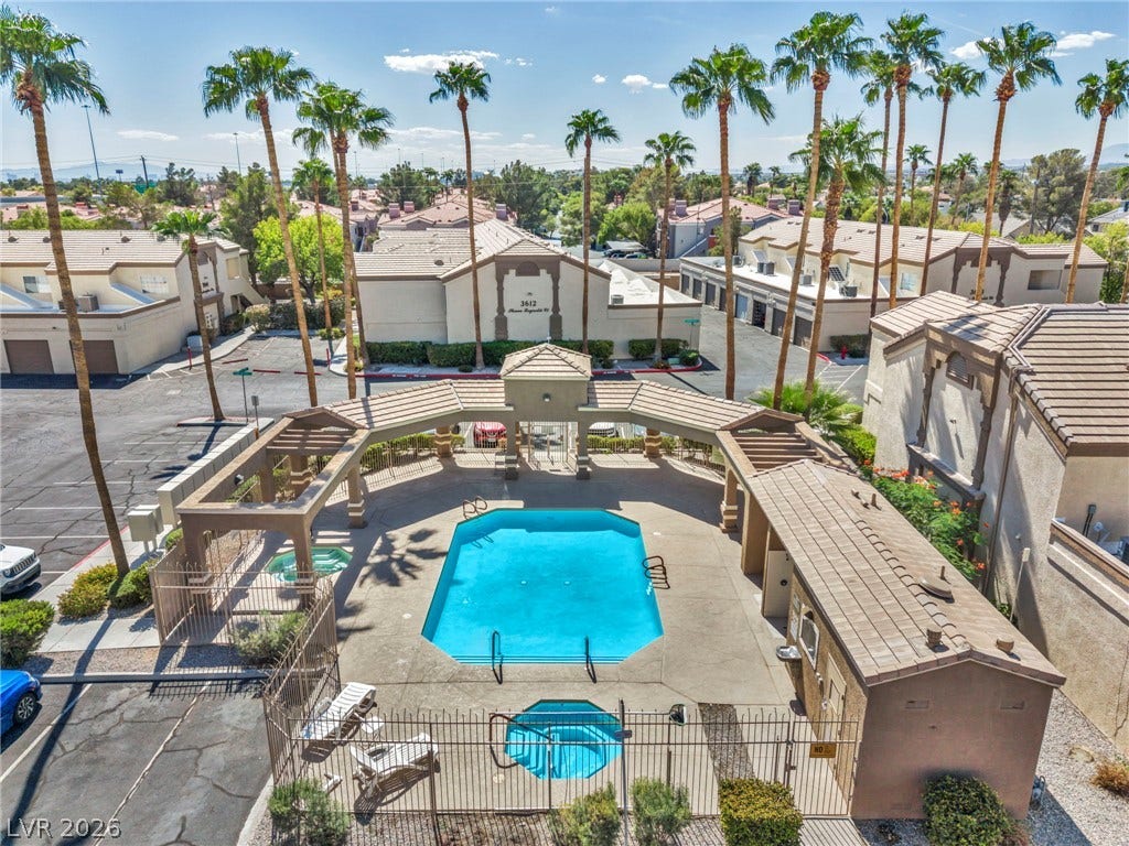 3613 Shawn Reynolds Court, #104, Las Vegas, NV 89129 Towering palm trees frame an inviting community swimming pool and spa area.