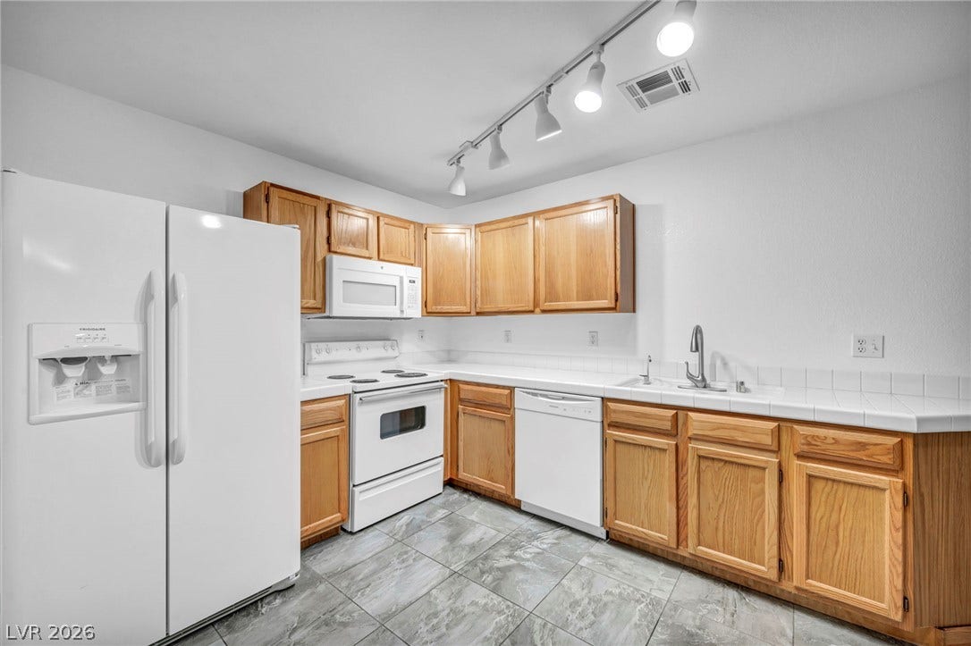 3613 Shawn Reynolds Court, #104, Las Vegas, NV 89129 Includes refrigerator, microwave and abundant ovrehead lighting.