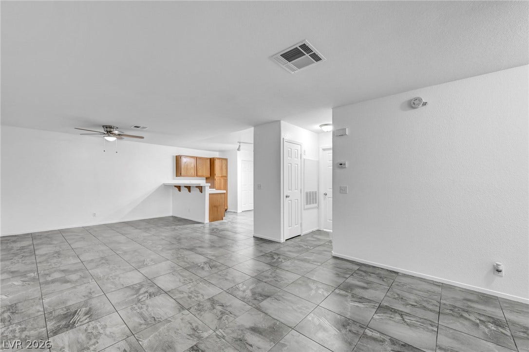 3613 Shawn Reynolds Court, #104, Las Vegas, NV 89129 Gleaming tile floors flow seamlessly through this open layout toward a practical breakfast bar.