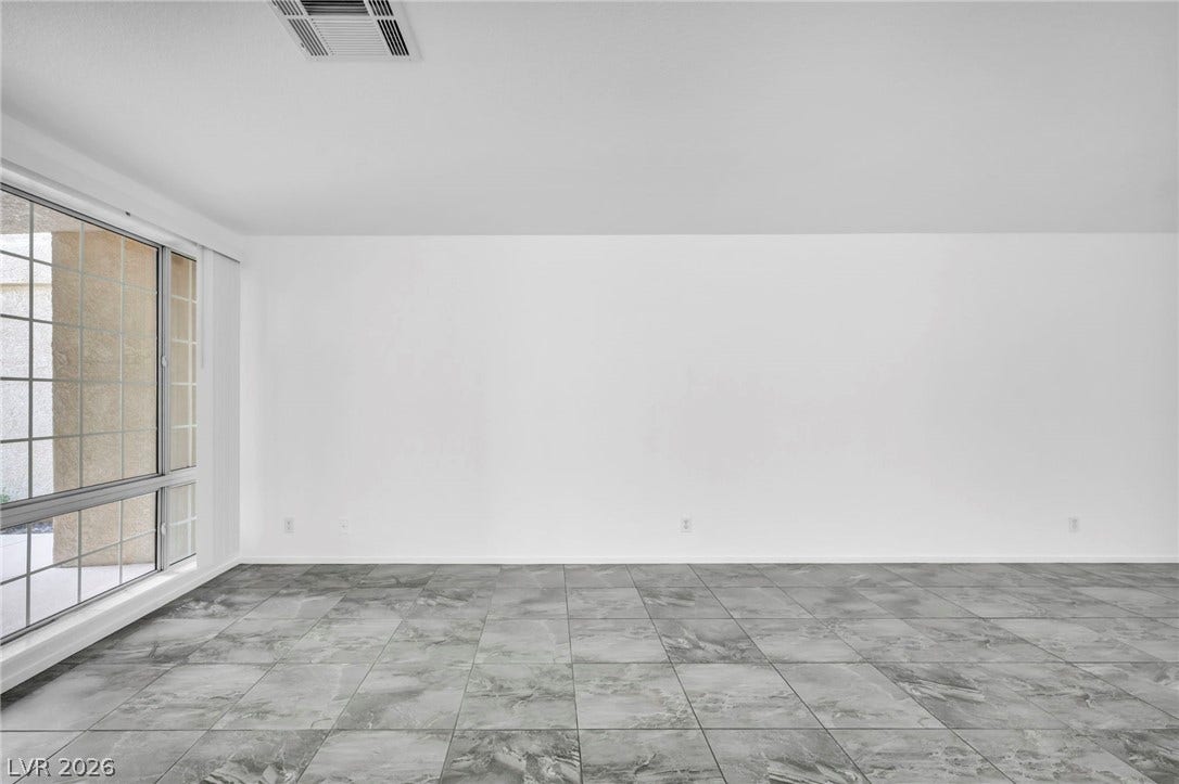 3613 Shawn Reynolds Court, #104, Las Vegas, NV 89129 Polished tile flooring and expansive windows establish a clean, modern aesthetic.