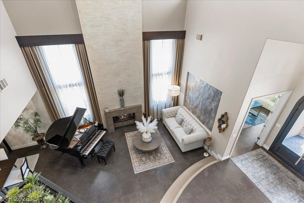 2985 American River Lane, Las Vegas, NV 89135 Spacious living area featuring a fireplace and tile flooring.