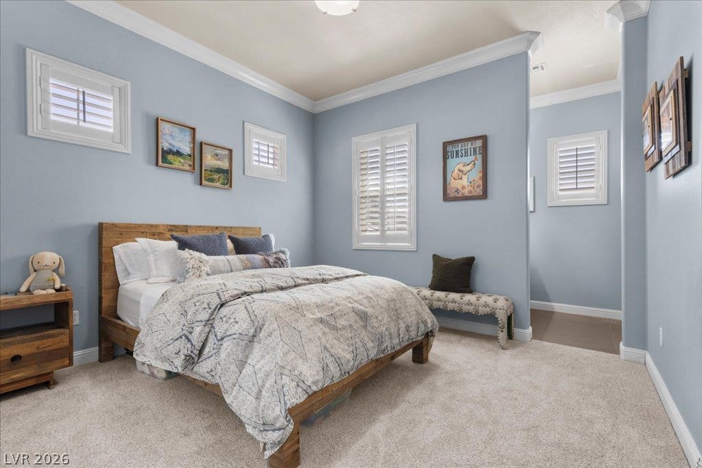 2985 American River Lane, Las Vegas, NV 89135 Inviting bedroom with crown molding and natural light.