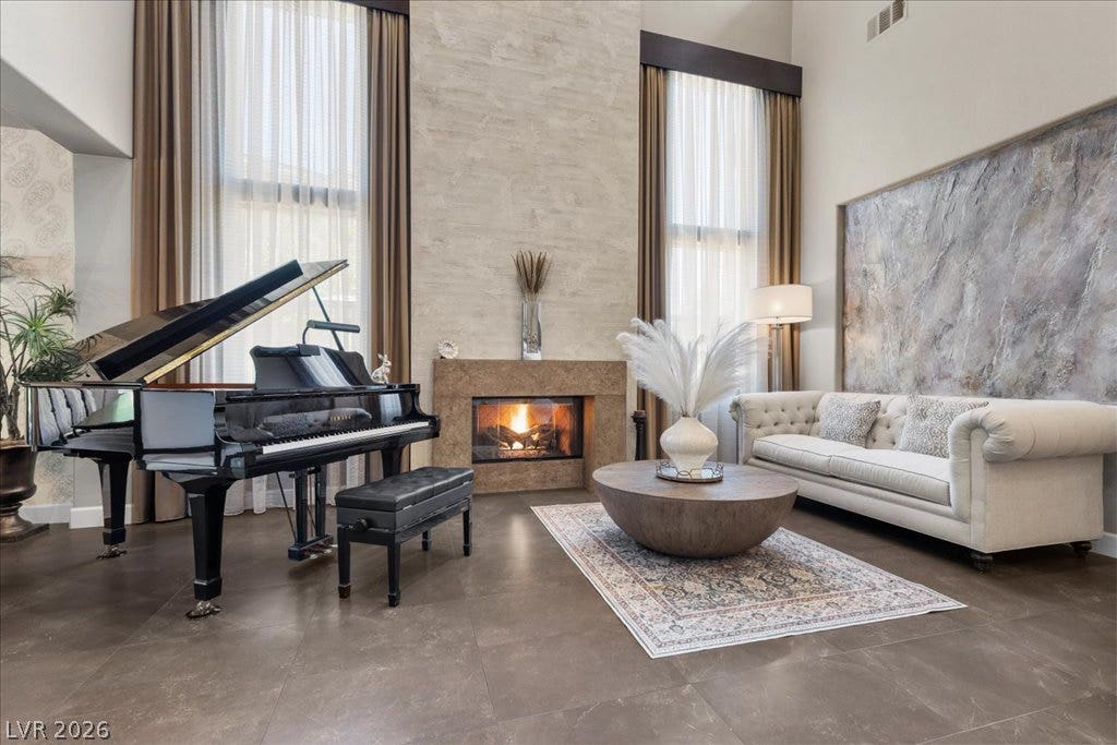 2985 American River Lane, Las Vegas, NV 89135 Soaring ceilings and a stunning fireplace create a dramatic focal point.
