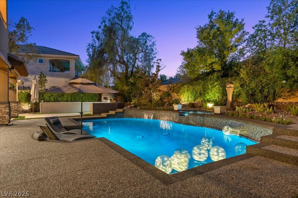 2985 American River Lane, Las Vegas, NV 89135 Private backyard retreat with a glowing pool.